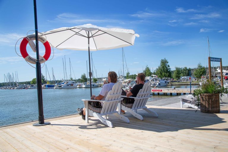 Two people eating ice-cream, overlooking the harbour